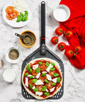 Perforated 12 Inch Pizza Peel, Metal Pizza Turner For All Ovens, Indoors and Outdoors Use, with a pizza and ingredients on marble countertop.