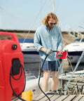 Man using 34 Gallon Fuel Caddy With Portable Design Manual Transfer Pump And 10 Ft Delivery Hose On Wheels Diesel And Gas Storage for Boats