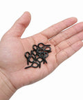 Hand holding 100 Pack 1 Inch Metal Screw Eyes Hooks Self Tapping Eye Rings For Indoor Outdoor Hanging Lifting And Securing Cables.