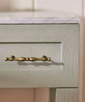 Antique Brass Cabinet Pulls Set Of 6, 5 Inch Center Drawer Handles with vintage design on a wooden cabinet drawer
