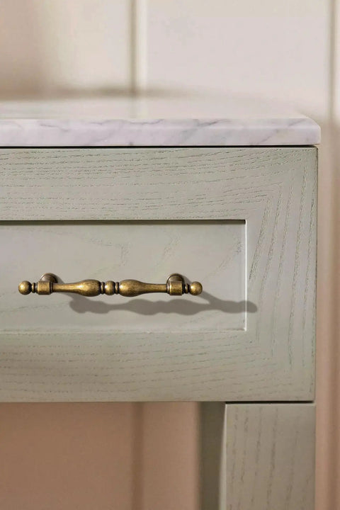 Antique Brass Cabinet Pulls Set Of 6, 5 Inch Center Drawer Handles with vintage design on a wooden cabinet drawer