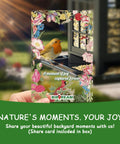 Hand holding a card with a bird image, titled 'A moment of joy captured forever,' with colorful floral borders.