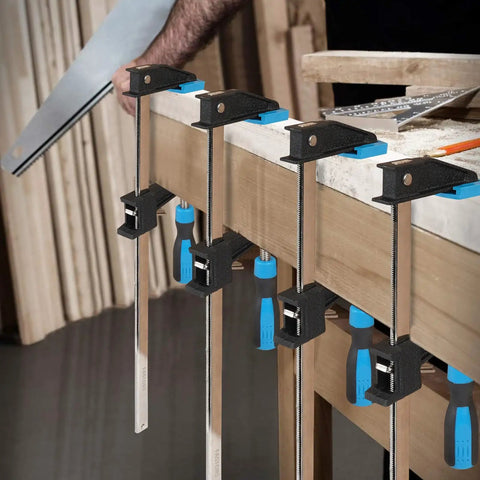 Workshop scene with 36 Inch Bar Clamps Set For Woodworking, 4 Pack attached to table, showing serrated steel rails and quick release grips.