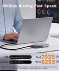 Person using a laptop with Beast Mode Speed M2 Nvme SSD Enclosure with Smart Cooling Fan for fast data transfer.