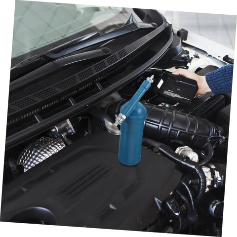 80cc Mini Grease Gun Portable Manual Lubrication Tool with Sky Blue Electroplated Finish next to car engine