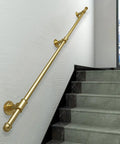 Beefy Gold Safety Handrail Crafted for Indoor Outdoor Staircase Railing No Sweat Setup Wall Anchors Rust Resistant Wrought Iron Grab Bar Banister Stable Support for Family 11 Foot mounted on wall next to staircase.