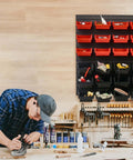 48 Bin Wall Mounted Storage Bins Rack Organizer for garage tools, featuring 24 small and 24 large bins, mounted on a wooden workshop wall.