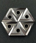 Top-down view of six TNMG carbide turning inserts with center holes, hexagonal arrangement, silver finish