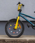 Child's bike with Colorful Flower Bike Spoke Beads Clip On Neon Glow In The Dark Decorations on wheel.
