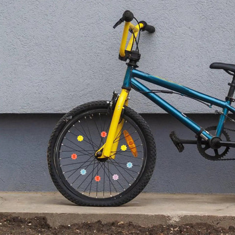 Child's bike with Colorful Flower Bike Spoke Beads Clip On Neon Glow In The Dark Decorations on wheel.