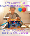 Child opening Epic Solar System Model Kit For Kids With 4 Speed Motor And HD Planetarium Projector. Gift wrap on the floor.