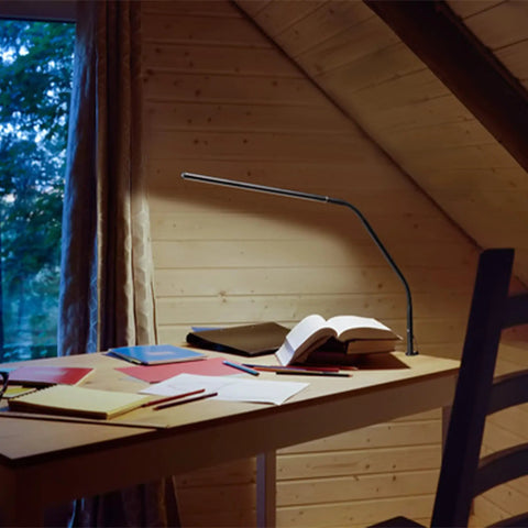 Black Dope Daylight Table Lamp With Realistic Daylight Simulation on a wooden desk with open books and papers, 20.75x8 inch size