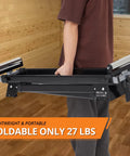 Person holding Built Tough Folding Miter Saw Stand, 27 lbs, portable and foldable, ideal for quick cuts in garage workstation.