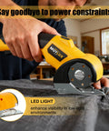 Heavy Duty Cordless Electric Scissors And Cardboard Cutter For Fabric, Plastic, Wood And Wrapping Paper With Safety Lock And LED Light being used to cut fabric.
