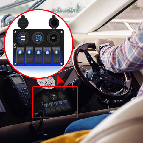 Waterproof 5 Gang Rocker Switch Panel With Aluminum Body For 12V To 24V Boats Cars RVs And Trucks Includes Dual USB Socket Volt Meter And Bright Blue LED Indicator Beefed Up Marine Grade Construction Easy DIY Install mounted on boat dashboard with steering wheel in view.