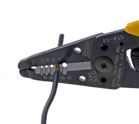 Close-up of Premium Reflex T5 Wire Stripper for 10 to 20 AWG with plier nose stripping wire, showing tough steel construction.