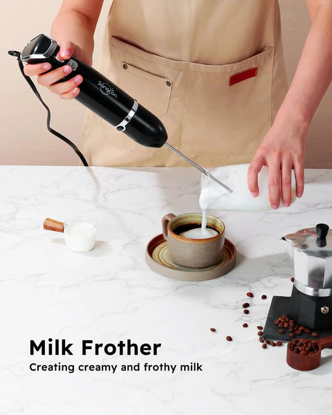 Person using Immersion Hand Blender All In One Electric Stick Blender With Whisk And Milk Frother Attachments 400W to froth milk