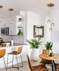 Three Light Crystal Cluster Pendant Chandelier In Gold Finish in kitchen dining area with modern décor.