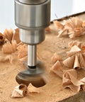 Heavy Duty Carbide Tipped Forstner Drill Bit Set Packs Sixteen Badass Sizes drilling clean hole in wood with shavings.