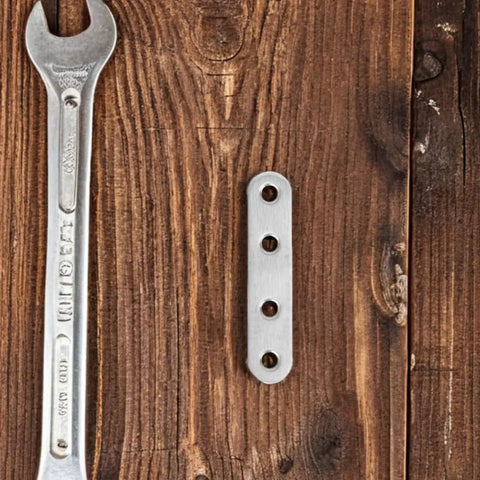 40Pcs Stainless Steel Flat Straight Braces Set With Precision Flat Design And Smooth Surface Finish on wooden background