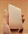 Hand holding 73x100mm copper strip board, Ten Pack 73 By 100 Millimeter Copper Strip Board With 957 Holes Perfboard Kit