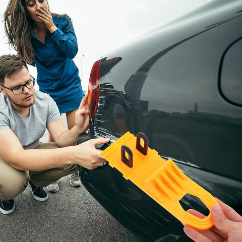 Professional Grade Paintless Dent Removal Kit Featuring Sturdy Pullers And Strong Glue Tabs To Knock Out Dinged Up Bumpers Fenders And Hoods Restore Your Banged Up Ride Clean Now in use on a black car.