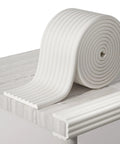 Super Snug W Shape Corner Protectors With Pre Taped Edge Guard For Furniture Safety Kid And Pet Friendly Home Bumper Roll on a wooden table.