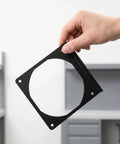 Hand holding Two Pack Metal Computer Fan Mount Bracket For 12cm PC Fans Sturdy Iron Construction Replacement Chassis Bracket To Boost Airflow And Keep Your Rig Cool And Clean And Easy To Install.