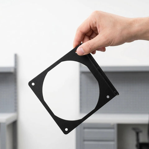 Hand holding Two Pack Metal Computer Fan Mount Bracket For 12cm PC Fans Sturdy Iron Construction Replacement Chassis Bracket To Boost Airflow And Keep Your Rig Cool And Clean And Easy To Install.