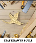 Brass Leaf Drawer Pulls For Cabinets And Wardrobes, Vintage Kitchen Cupboard Hardware, leaf-shaped design on wooden surface