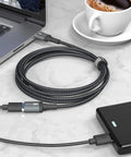 Ultra Long 10FT USB 3.0 Extension Cable Type A Male To Female for charging on a desk with a laptop and power bank.