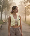 Woman wearing Running Hydration Vest for Women and Men with 500ml BPA Free Soft Flask, Adjustable Chest Straps in yellow