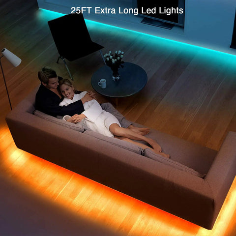 Couple on sofa with 25 Foot RGB LED Strip Lights Kit With 44 Key Remote And 12V Power Supply illuminating room edges