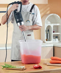Person using Beast 750W Commercial Immersion Blender With 20 Inch Shaft Copper Motor Variable Speed 304 Stainless Steel Blade in kitchen.