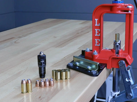 Dead Nuts Accurate Rifle Micrometer Adjustment Screw For Universal Bullet Seating Dies Infinite Tweakability Laser Engraved Point Zero One Inch Markings Silent Friction Ring Kills Clicks Smooth Die Swap For Gear Heads on a reloading press with bullets and brass cases.
