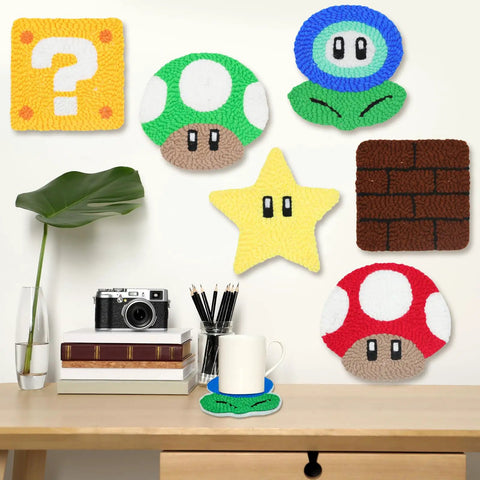 Punch Needle Coaster Kit For Easy DIY Embroidery 6 Piece All In One Set With Fun Patterns Tools Yarns Hoop Instructions And Coaster Holder For Beginners Kids And Adults featuring colorful video game themed coasters on a desk setting.
