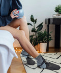 Person wearing Death Scythe Ankle Socks With Moisture Wicking Tech in a cozy home setting
