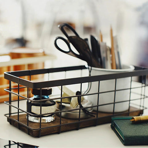 Farmhouse Small Metal Wire Storage Basket With Wooden Bottom Black Rustic Organizer on desk with stationery and ink bottle.