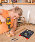 Person using a drill with 26 Piece DIY Woodworking Tools Set with Countersink Bits, Plug Cutters, and other accessories visible nearby.