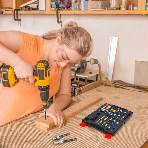 Person using a drill with 26 Piece DIY Woodworking Tools Set with Countersink Bits, Plug Cutters, and other accessories visible nearby.