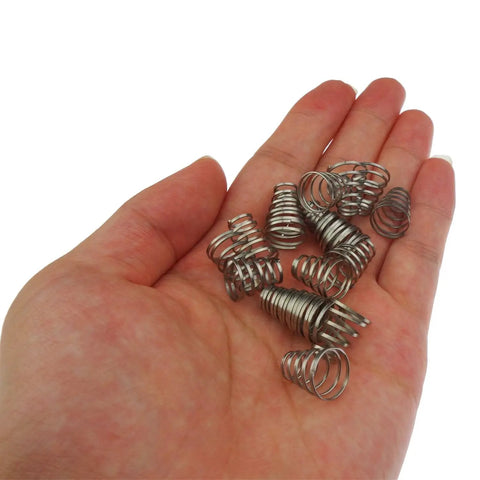 Hand holding Four Pack 304 Stainless Steel Universal Quick Release Bike Wheel Skewer Springs for front and rear skewers