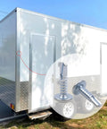 10 X 3/4 Inch Self Tapping Sheet Metal Screws For Enclosed Trailers No Sweat Install Cranks Right In Without Pre Drilling Locks Tight Hold Corrosion Resistant Finish Hardware affixed on a cargo trailer's panel.