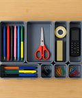 8 Piece Interlocking Drawer Organizer Trays Set In Light Gray Plastic, Modular Storage Bins For Kitchen, Bathroom, Office And Desk Drawers, Customizable To Fit Any Size Drawer, Non Slip And Mess Free containing office supplies like pens, scissors, tape.