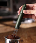 Dope Pink Magnetic Telescopic Coffee Distribution Needle And Rock Solid Stainless Steel Espresso Grounds Leveler in use, distributing coffee grounds.