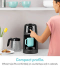 Woman using Brew Choice Pod and Carafe Coffee Maker for K Cup Pods or Ground Coffee, 12 Cup Capacity, on countertop