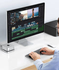 Person using a Mac Mini with a Plug And Play 40Gbps M2 NVMe SSD Enclosure For Mac Mini M4 And Pro for video editing.