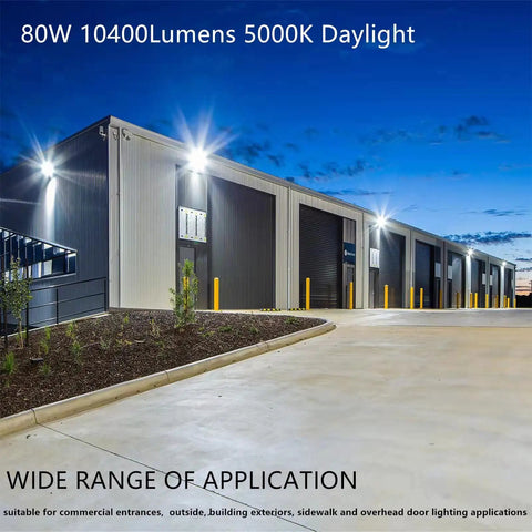 80W LED Wall Pack Light With Dusk To Dawn Photocell illuminating a warehouse exterior, showing bright 5000K daylight at night