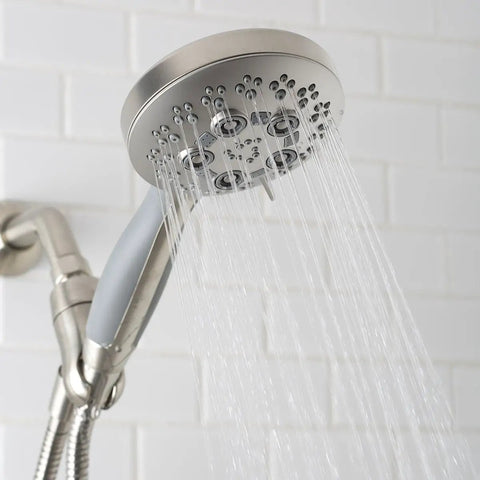 Rio Handheld Shower Head With 5 Sprays And 2.5 GPM Flow In Brushed Nickel, mounted on white tile wall