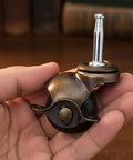 Heavy Duty 1.5 Inch Ball Casters With Secure Lock Brake Furniture Movers Set Of 4 Smooth Polyurethane Rollers in hand.
