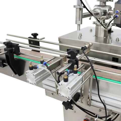 Close-up of Badass Auto Liquid Filling Machine With Single Head Servo Pump and Steel Conveyor Belt components and valves.